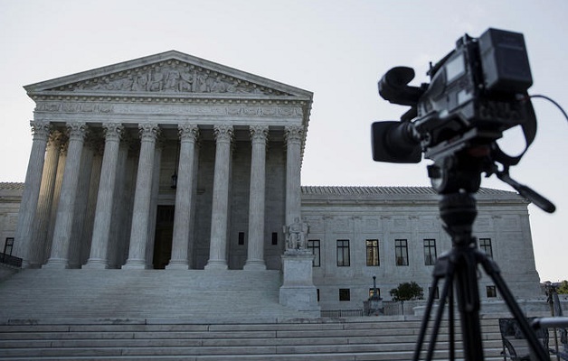 A camera sits on a tripod in front of the U.S. Supreme Court in Washington, D.C., U.S., on Monday, June 22, 2015. The high court will decide by the end of the month whether the Constitution gives gays the right to marry. The court's actions until now have suggested that a majority of the nine justices will vote to legalize same-sex weddings nationwide. Photographer: Drew Angerer/Bloomberg via Getty Images